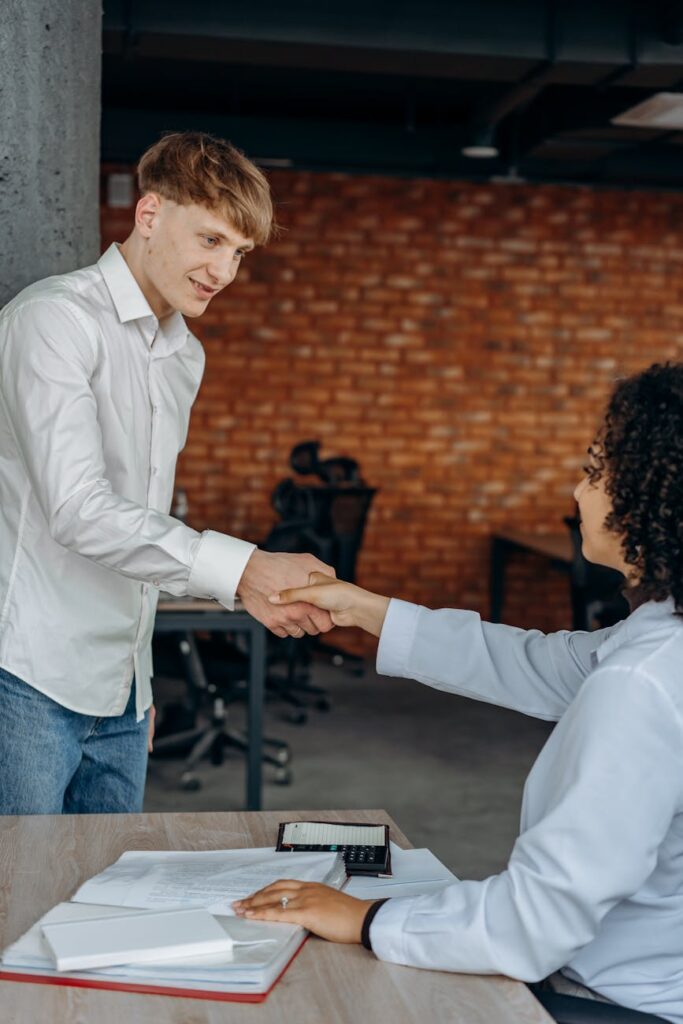 a man shaking a woman s hand